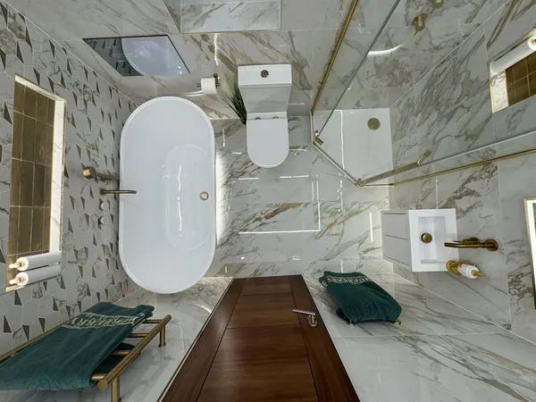 Professional tiler installing large format tiles in luxury bathroom Hull